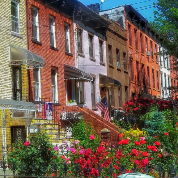 A row of homes with vibrant gardens