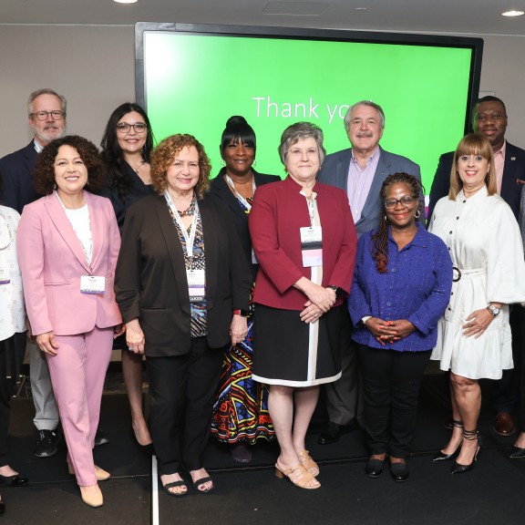 Inclusiv board members pose on stage at 50th anniversary conference