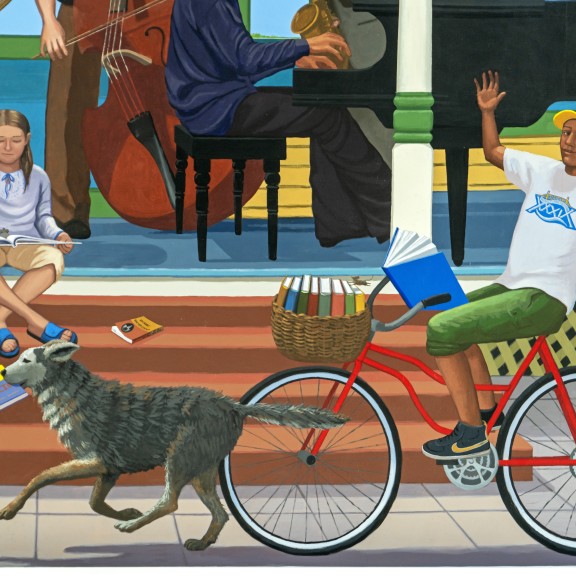 Mural of a child riding a bike with a dog running in front