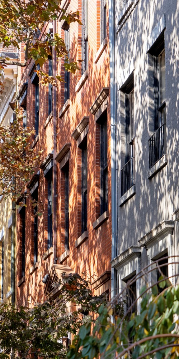 Manhattan rowhouses with fall leaves