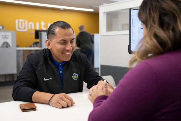 Unitus Credit Union staff serving a member