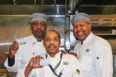 3 chefs who are members of Government Printing Office FCU pose with their debit/credit cards