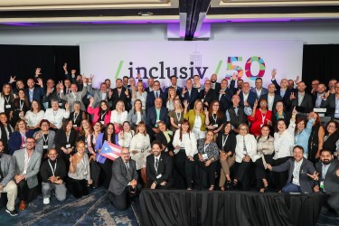 Inclusiv members from Puerto Rico pose on stage at our 50th anniversary conference