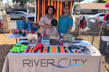 2 River City FCU staff members tabling at a community event 