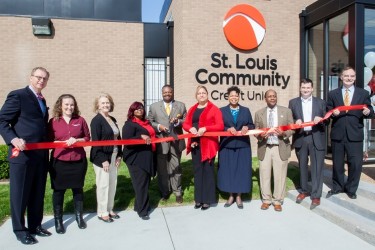 A line of St Louis Community CU staff cut the ribbon on a new branch