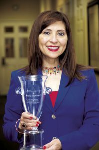 Border FCU CEO Maria Martinez, pictured with her 2017 Herb Wegner Memorial Award for Outstanding Individual Achievement from the National Credit Union Foundation.